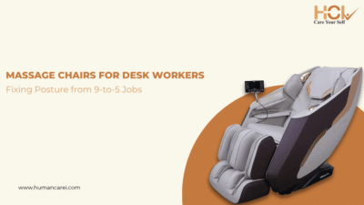 Man working at office desk with a massage chair beside him for posture and back pain relief